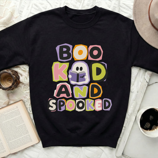 Black sweatshirt with "Boo Kad and Spooked" text and ghost reading book.