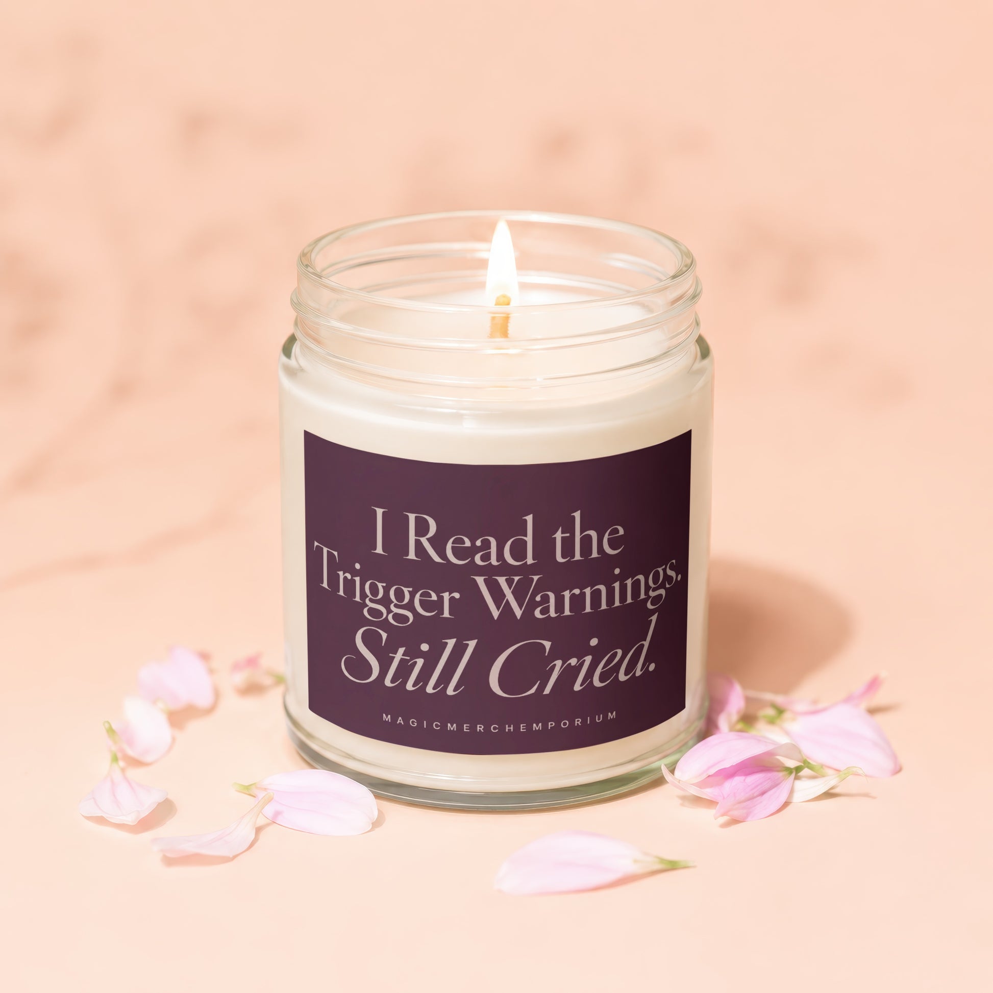 Candle with text "I Read the Trigger Warnings. Still Cried." surrounded by pink petals.