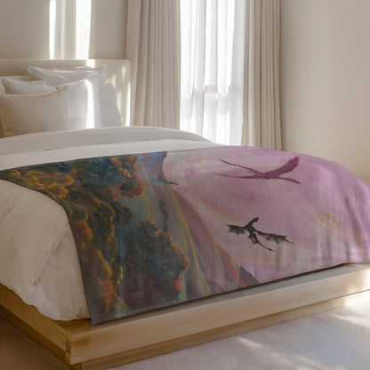 Dragon artwork on a comforter draped over a bed with soft lighting.