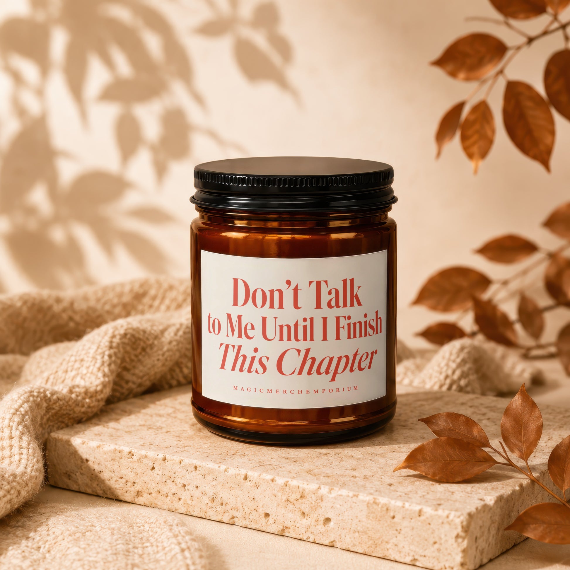 Amber candle with a white label reading "Don't Talk to Me Until I Finish This Chapter".