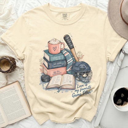 Cream Comfort Colors t-shirt with stacked books, hockey gear, and text.
