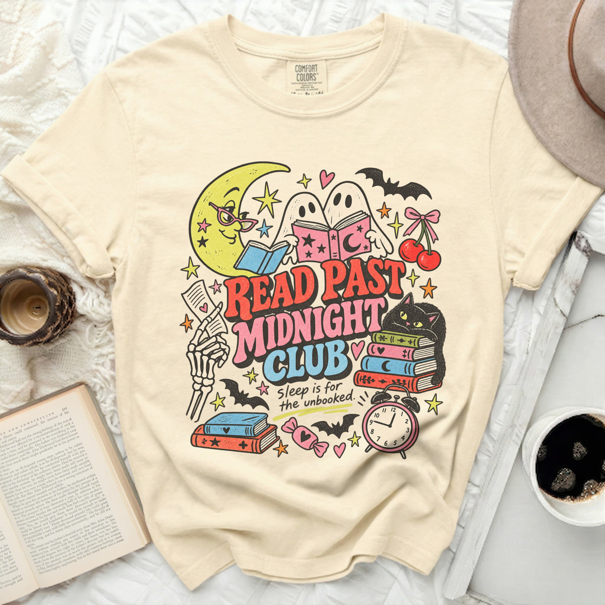Cream t-shirt with "Read Past Midnight Club" graphic featuring ghosts, moon, and books.