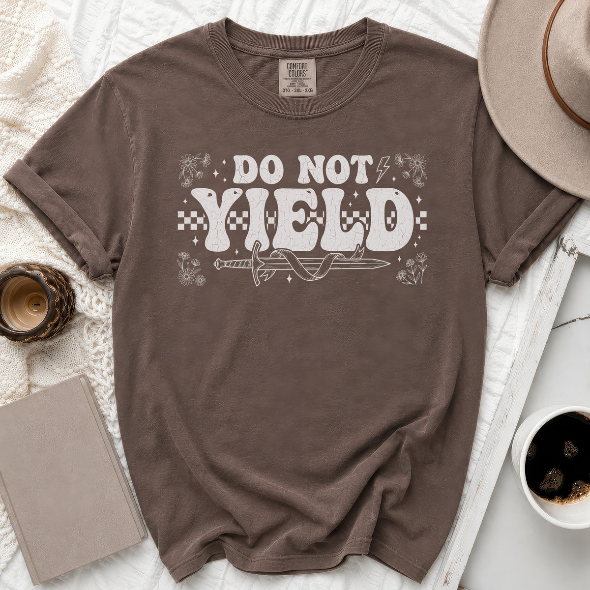 Brown t-shirt with "DO NOT YIELD" text, sword, and flowers graphic.