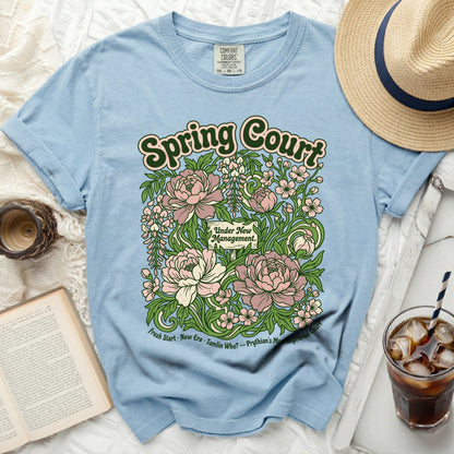 Light blue t-shirt with "Spring Court Under New Management" floral design.