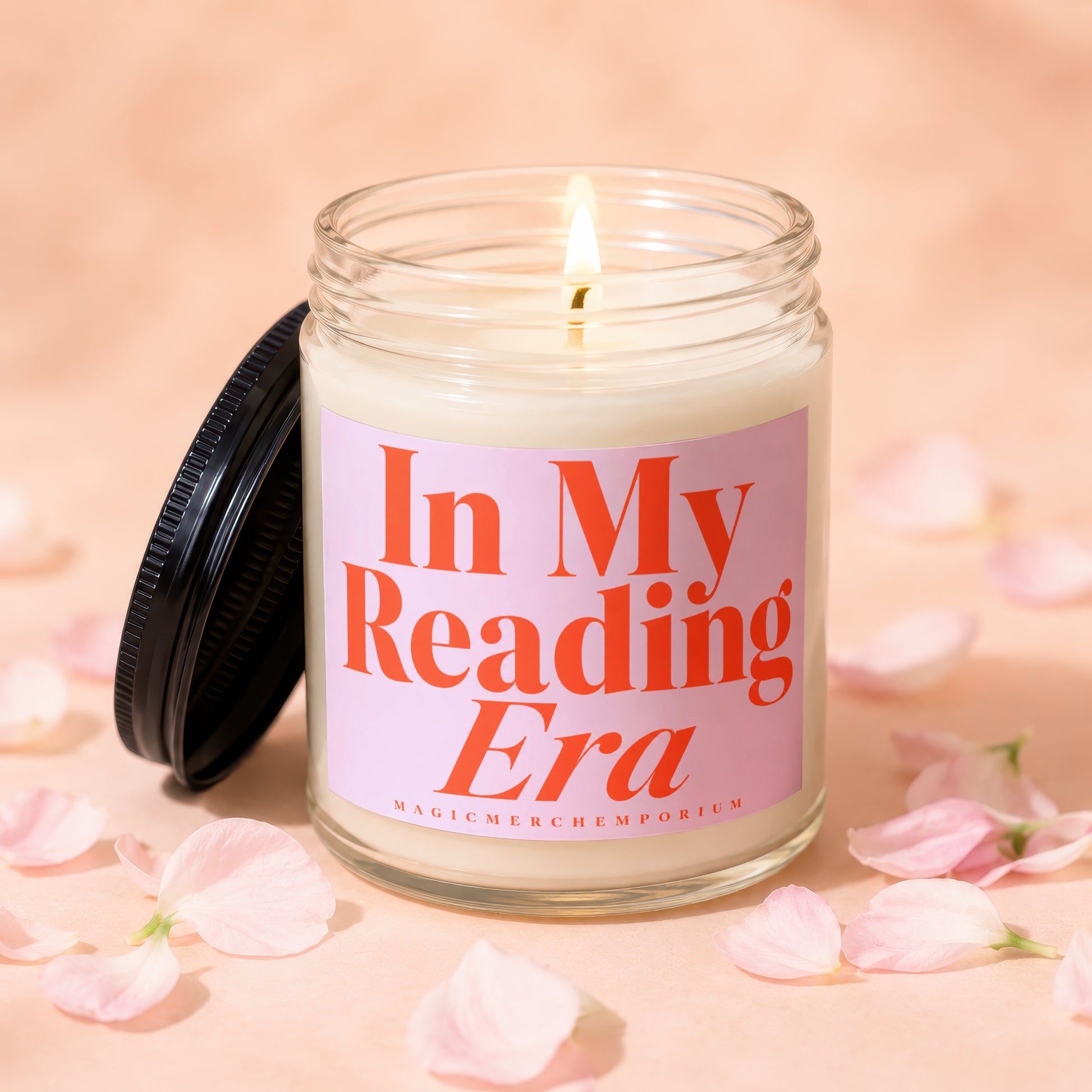 Candle with lit wick and pink label reading "In My Reading Era".