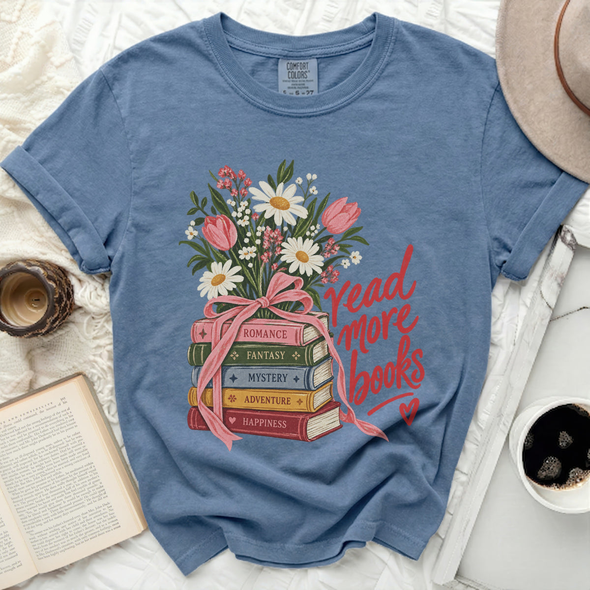 Blue t-shirt with stack of books, flowers, and "read more books" text.