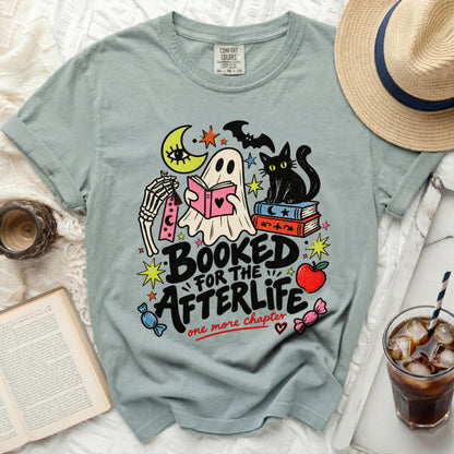 Ghost reading book with black cat and moon, text "Booked for the afterlife".