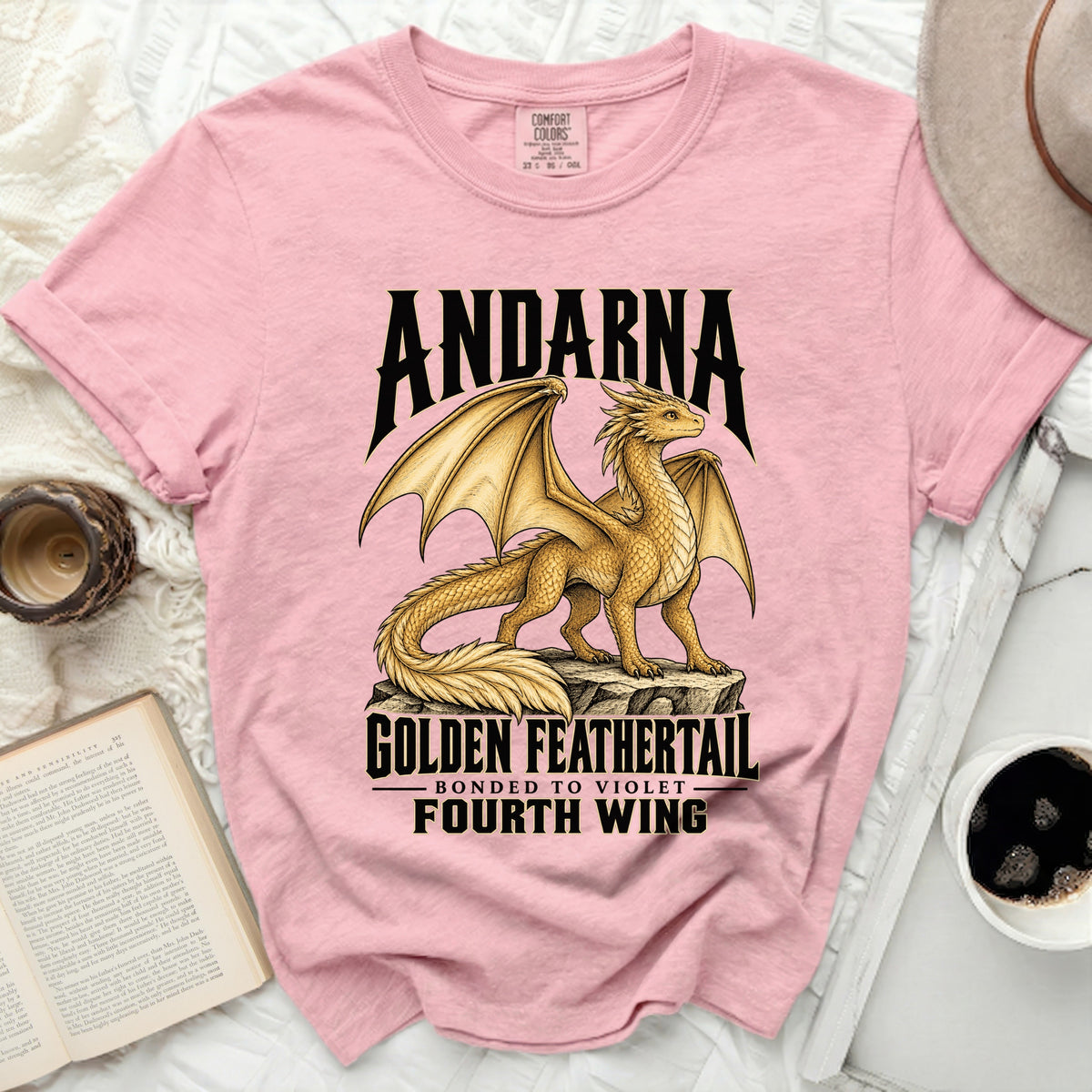 Pink t-shirt with "Andarna Golden Feathertail" dragon design and "Fourth Wing".