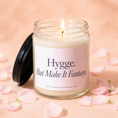 Lit jar candle with pink label that reads "Hygge. But Make It Fantasy."