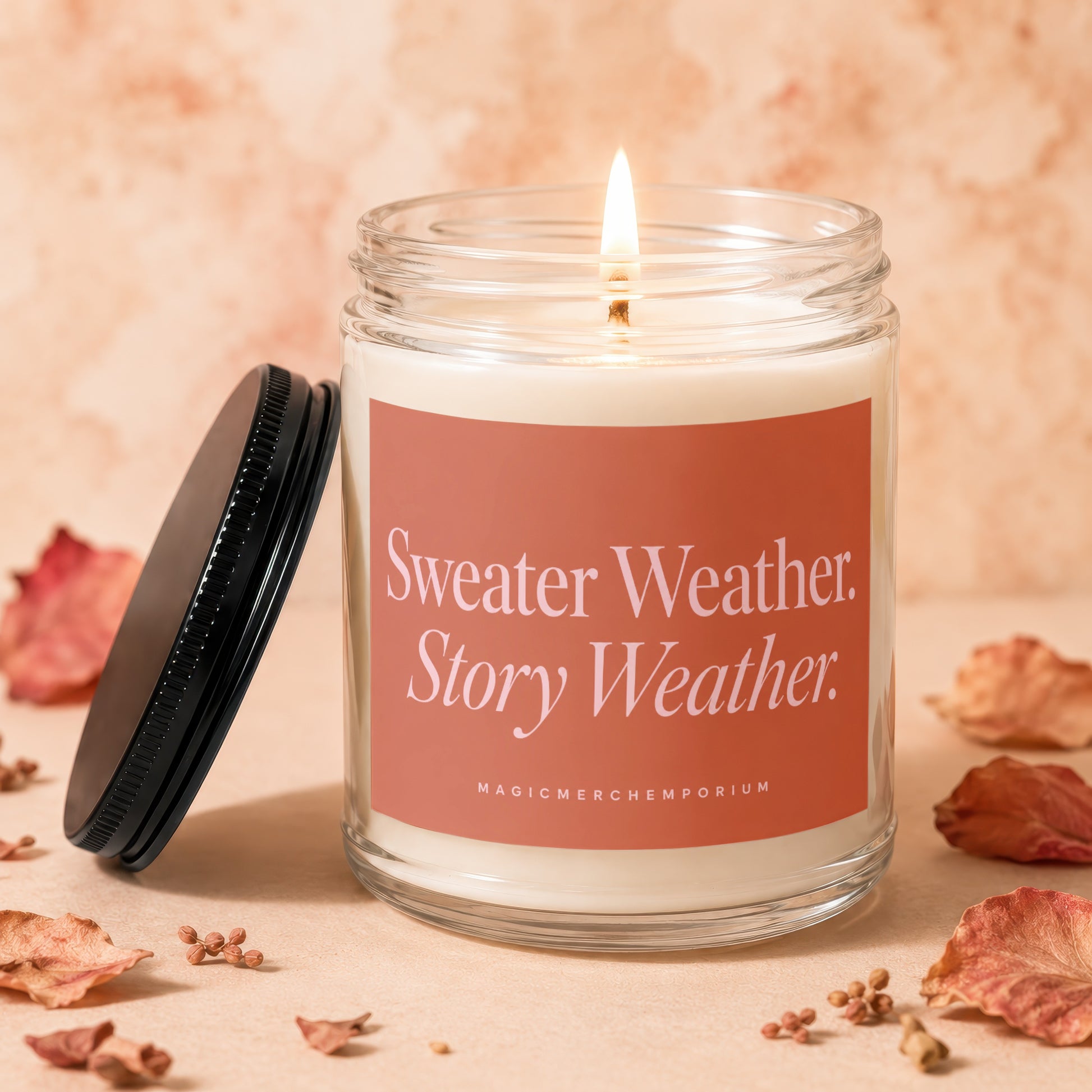 Candle in a glass jar with a black lid, reading "Sweater Weather. Story Weather."