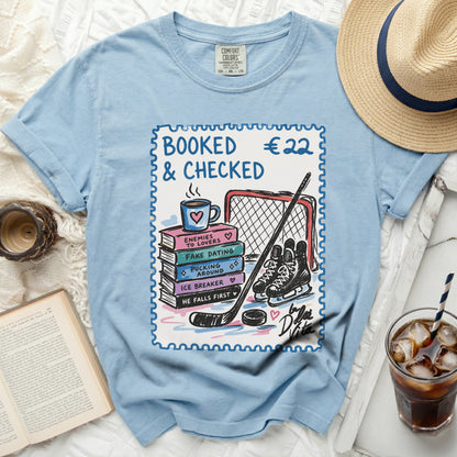 Light blue Comfort Colors t-shirt with hockey theme graphic and text.