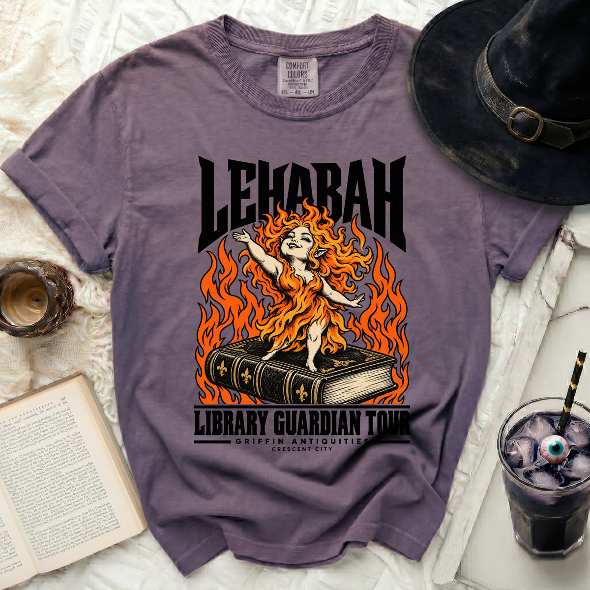 Purple t-shirt with "LEHABAH LIBRARY GUARDIAN TOUR" text and fiery creature.