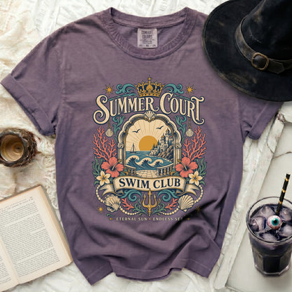 Purple t-shirt with "Summer Court Swim Club" graphic featuring a coastal scene.