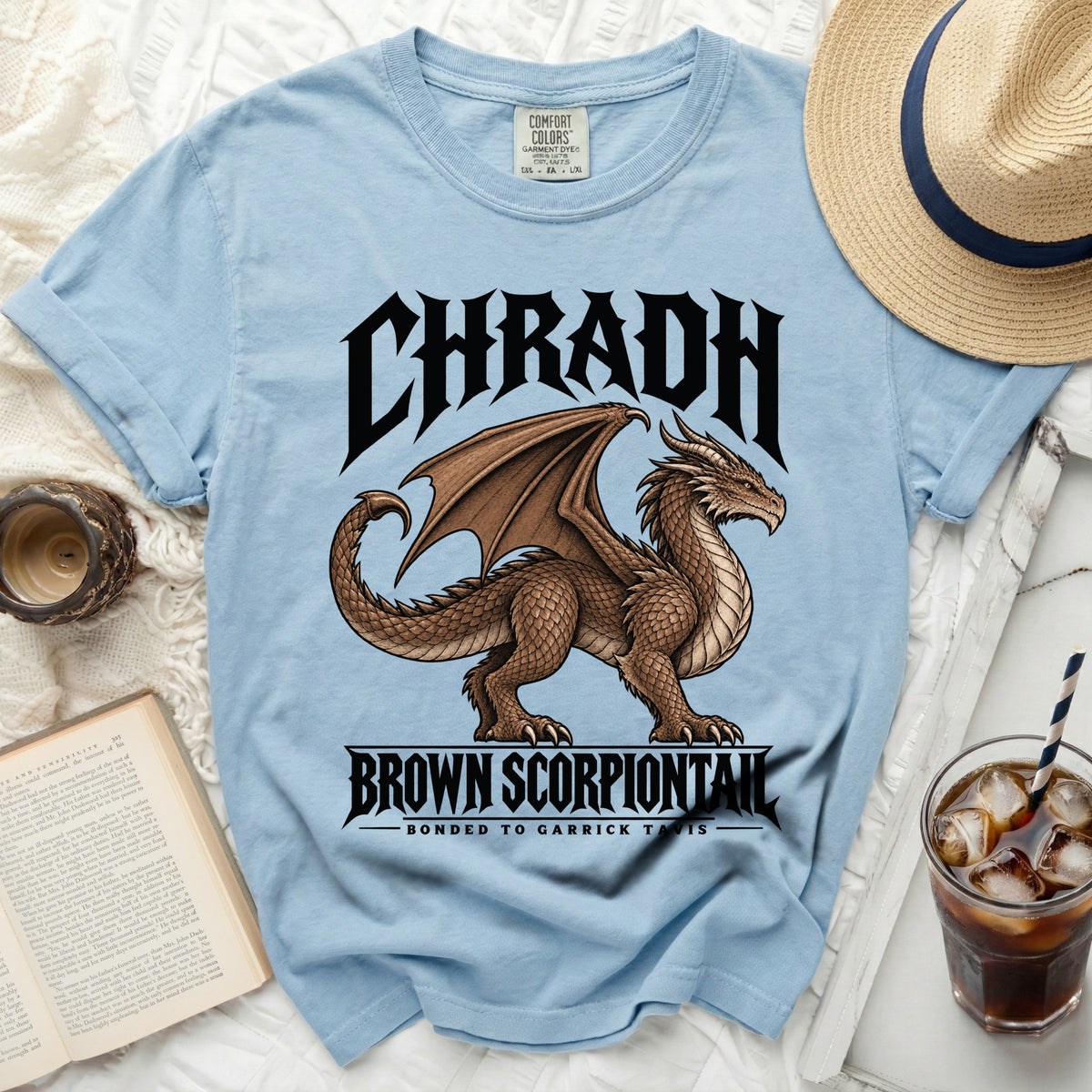 Light blue t-shirt with a brown dragon graphic and text "CHRADH BROWN SCORPIONTAIL".