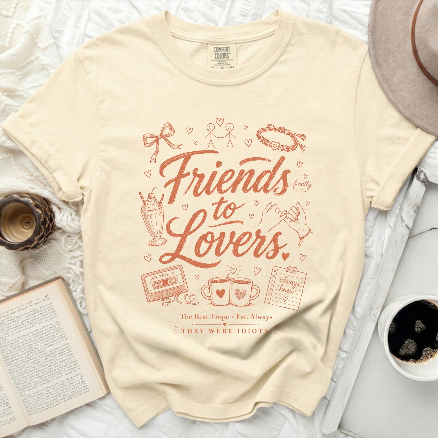 Cream t-shirt with "Friends to Lovers" graphic and vintage icons.