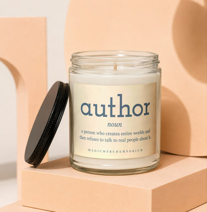 Glass jar candle with "author" definition label on a cream background.