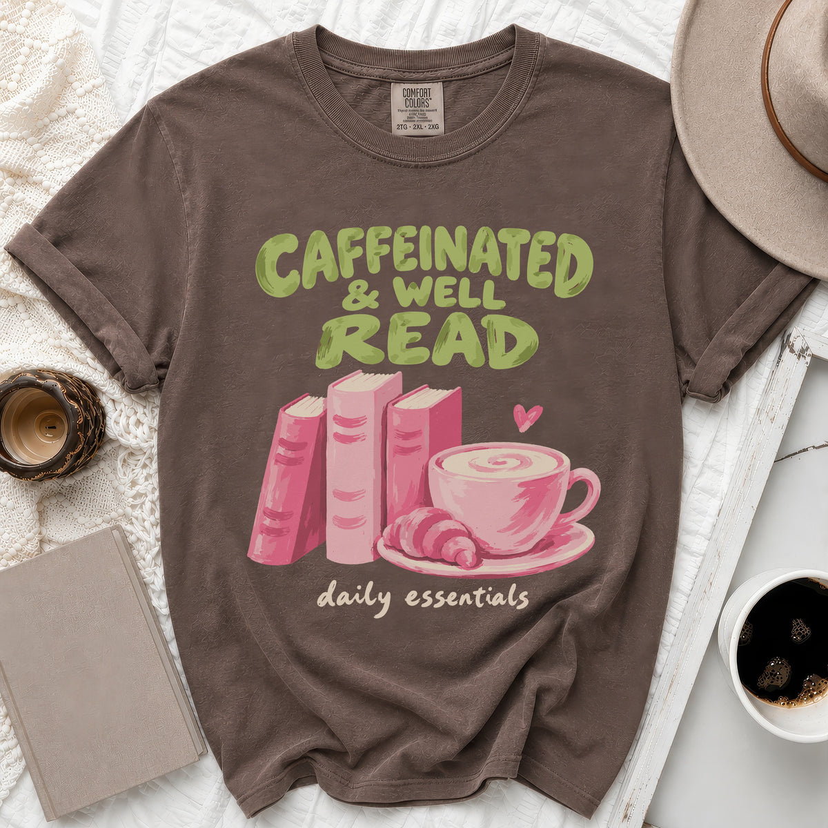 Brown t-shirt with "Caffeinated & Well Read" text, books, coffee, and croissant graphic.