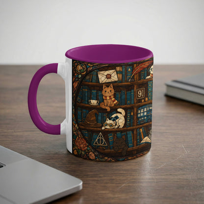 Mug with purple handle, featuring cats among books, a hat, and "9 3/4".