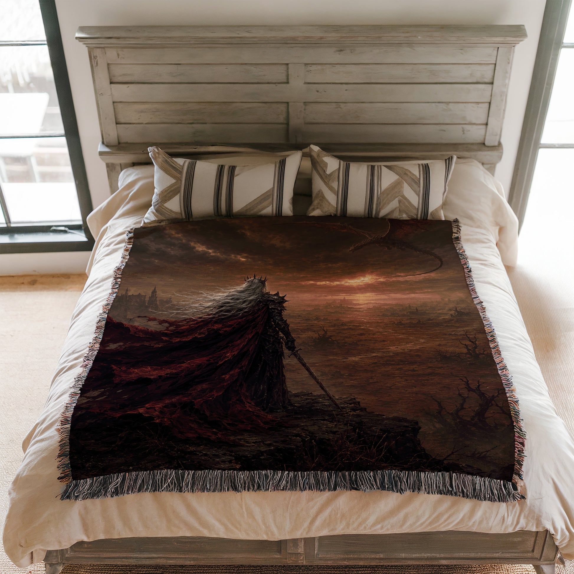 a bedroom with a bed covered in a large, colorful blanket featuring a dark, fantastical landscape.