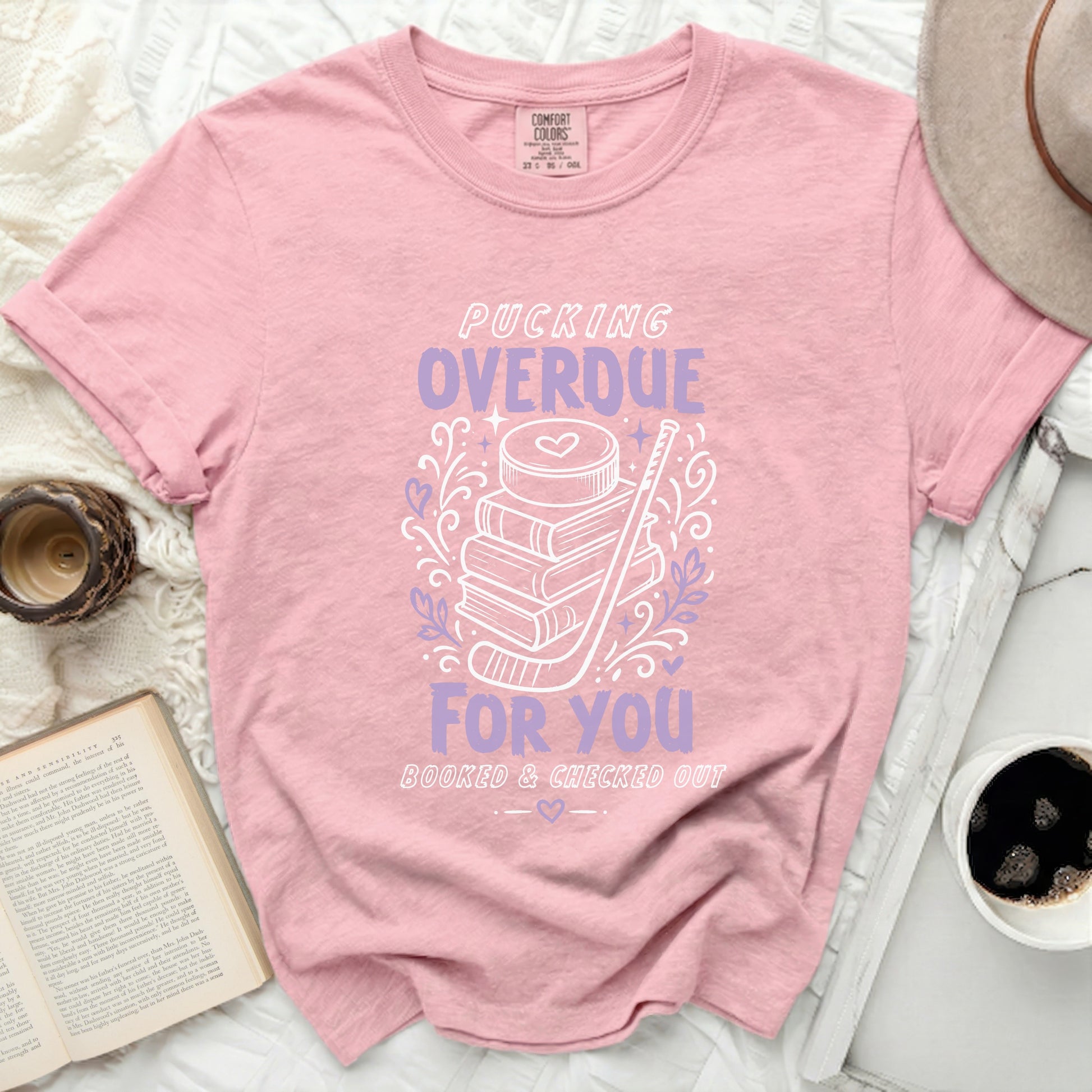Pink t-shirt with pucking overdue booked and checked out text.