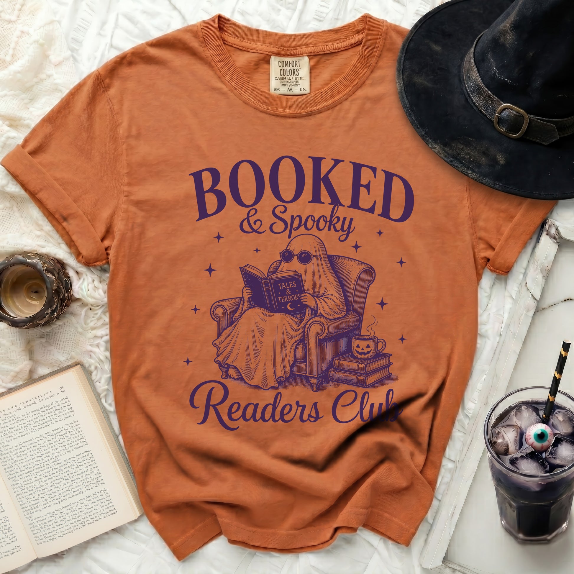 Orange t-shirt with purple design of ghost reading "Booked & Spooky Readers Club"