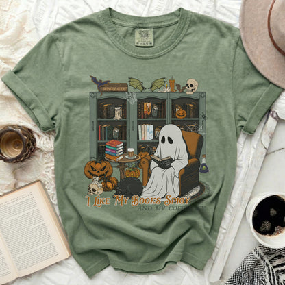 Green t-shirt with ghost reading and text "I LIKE MY BOOKS SPICY AND MY COFFEE".