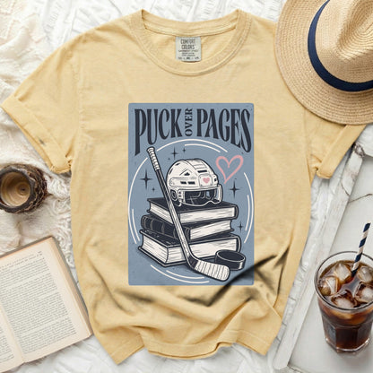 Yellow t-shirt with "PUCK OVER PAGES" text and hockey gear graphic.