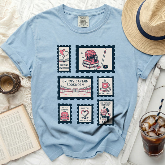 Light blue t-shirt with stamp designs of hockey gear and couples.
