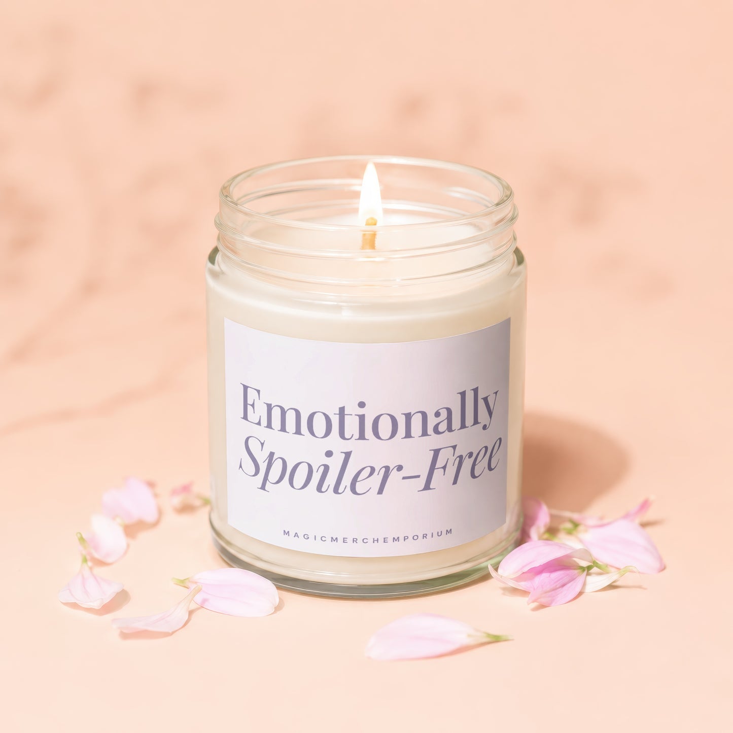 Glass jar candle with lit wick, label reads "Emotionally Spoiler-Free".