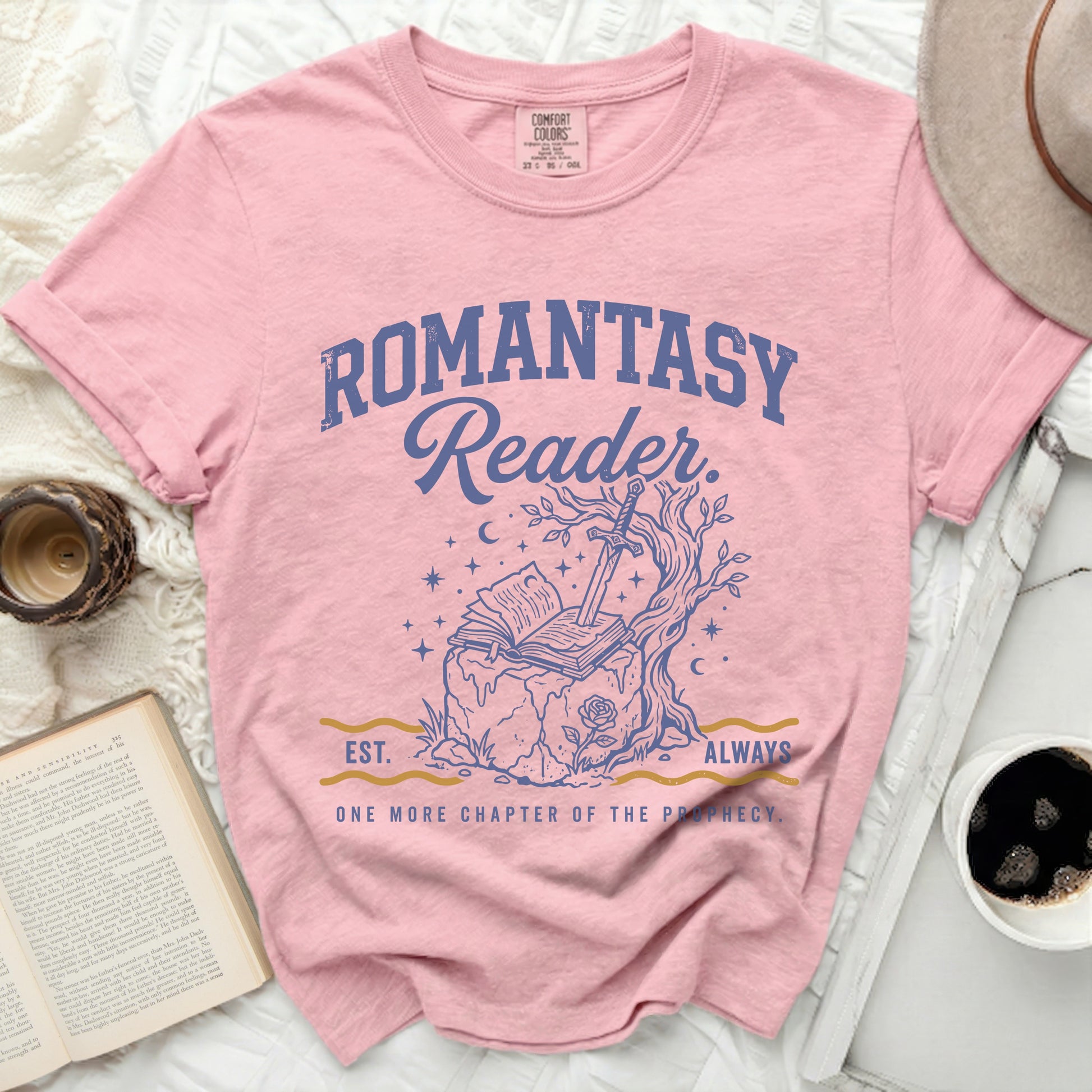 Pink t-shirt with "Romantasy Reader" and sword in book graphic.