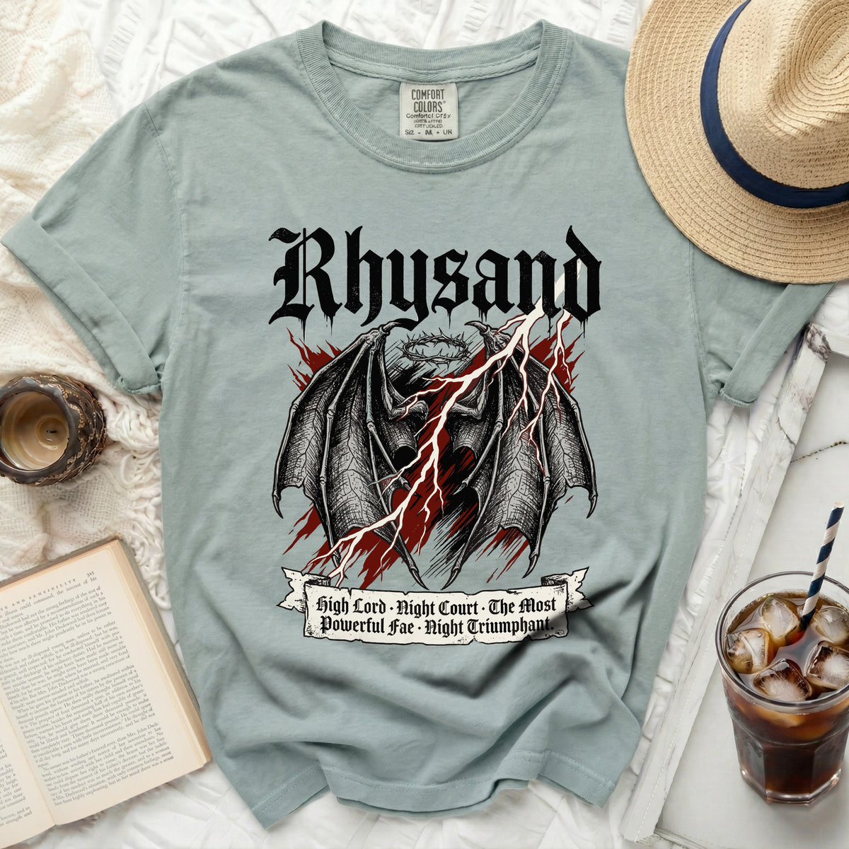 T-shirt with black graphic featuring wings, crown, and lightning, reads "Rhysand" and "High Lord · Night Court · The Most Powerful Fae · Night Triumphant."