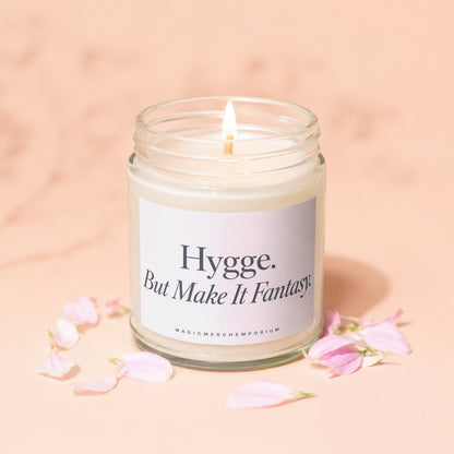 Jar candle with lit wick and label reading "Hygge. But Make It Fantasy."