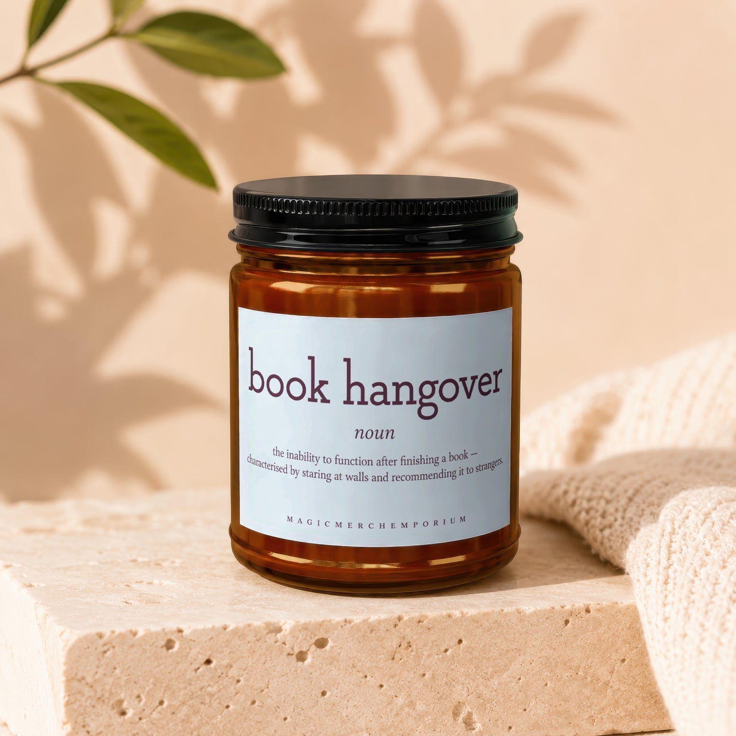 Amber jar candle with "book hangover" definition label.