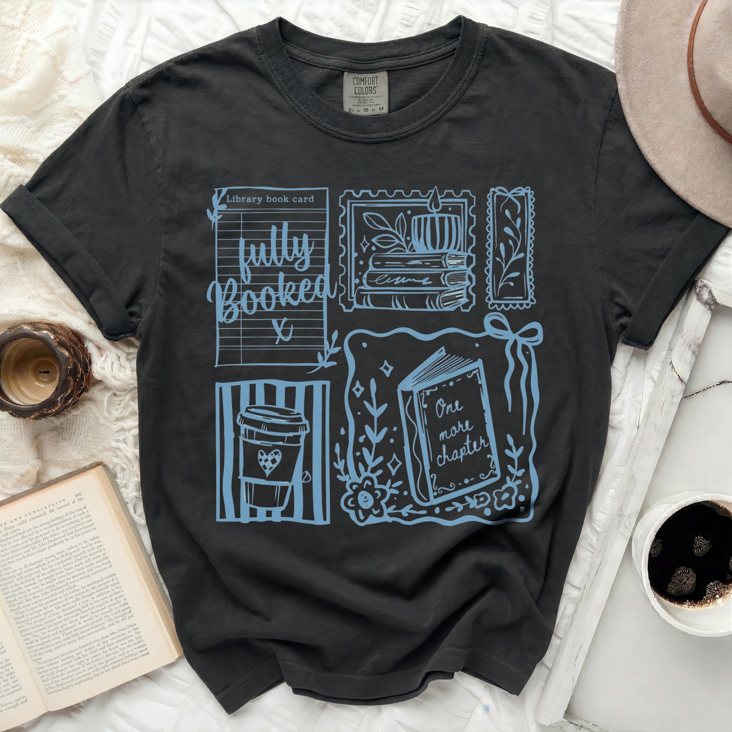 Black t-shirt with blue library book card and coffee cup graphic.