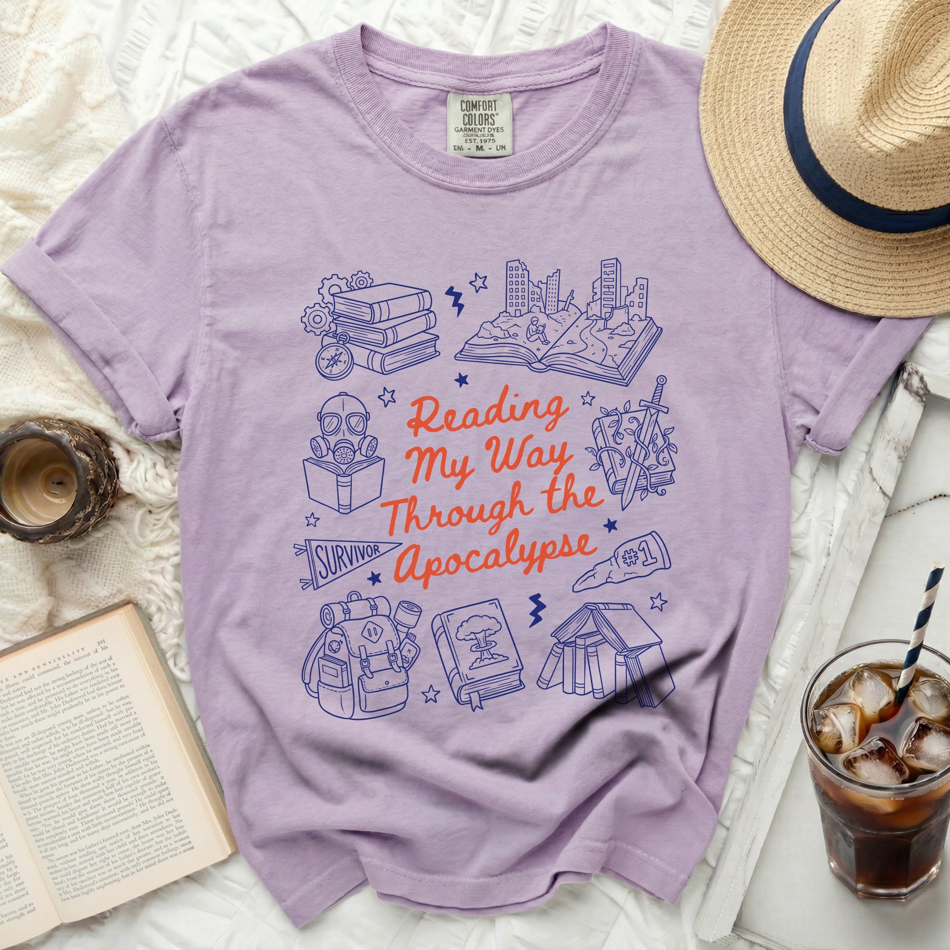 Purple Comfort Colors shirt with "Reading My Way Through the Apocalypse" graphic.