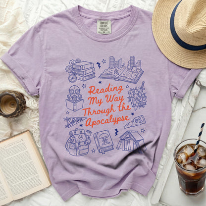Purple Comfort Colors shirt with "Reading My Way Through the Apocalypse" graphic.