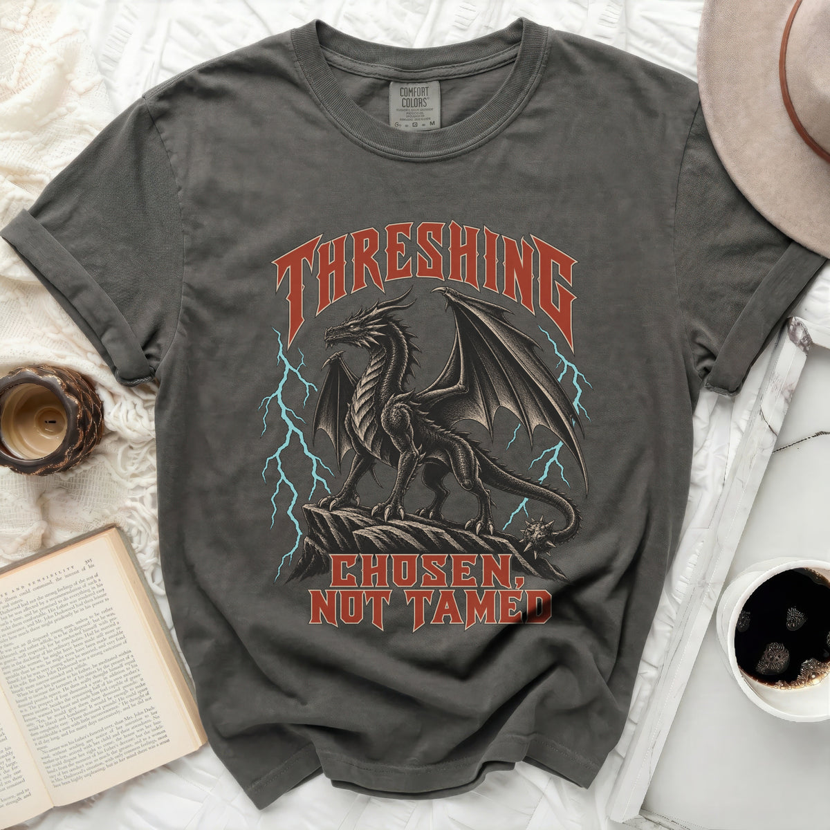 Dark grey t-shirt with a black dragon graphic and text "THRESHING CHOSEN, NOT TAMED".