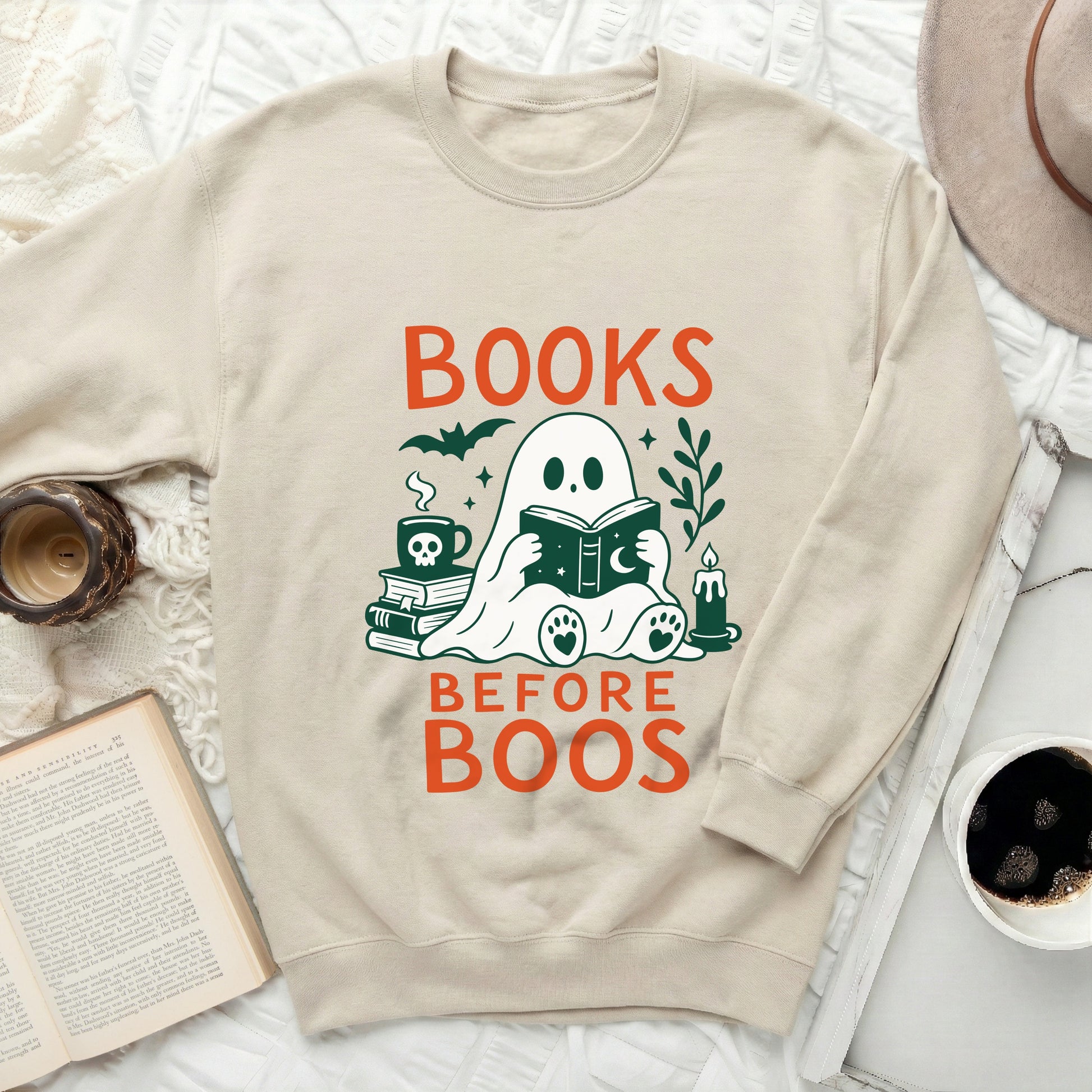 Cream sweatshirt with "BOOKS BEFORE BOOS" graphic featuring a ghost reading.