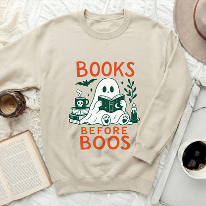 Cream sweatshirt with "BOOKS BEFORE BOOS" graphic featuring a ghost reading.
