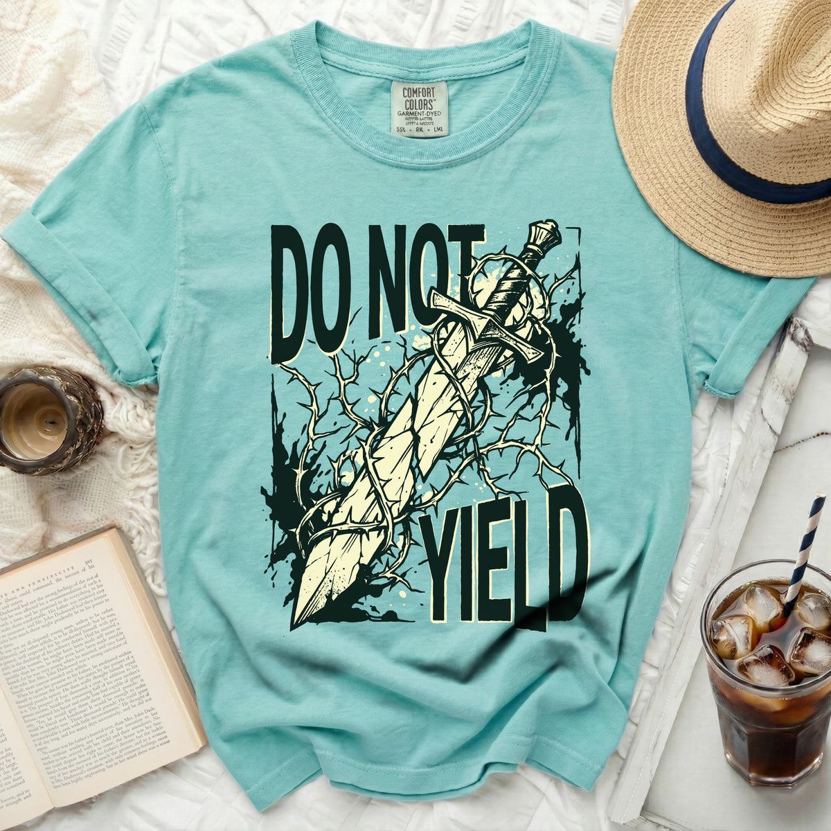 Aqua t-shirt with graphic text "DO NOT YIELD" and a sword with thorns.