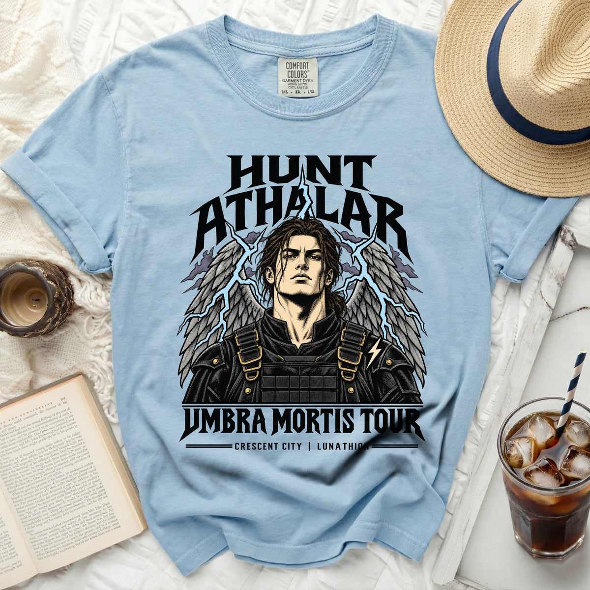 Light blue Comfort Colors t-shirt with Hunt Athalar graphic and "Umbra Mortis Tour" text.