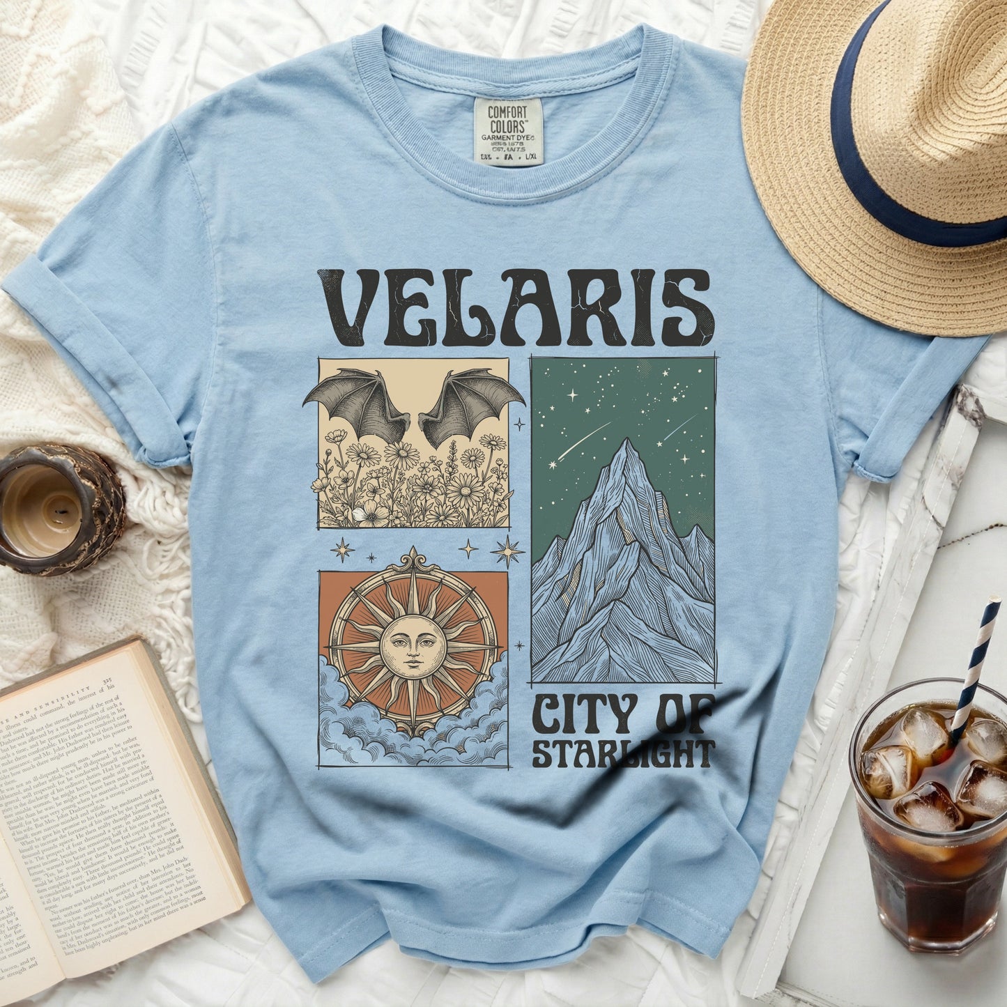 Light blue t-shirt with "VELARIS CITY OF STARLIGHT" graphic and celestial designs.
