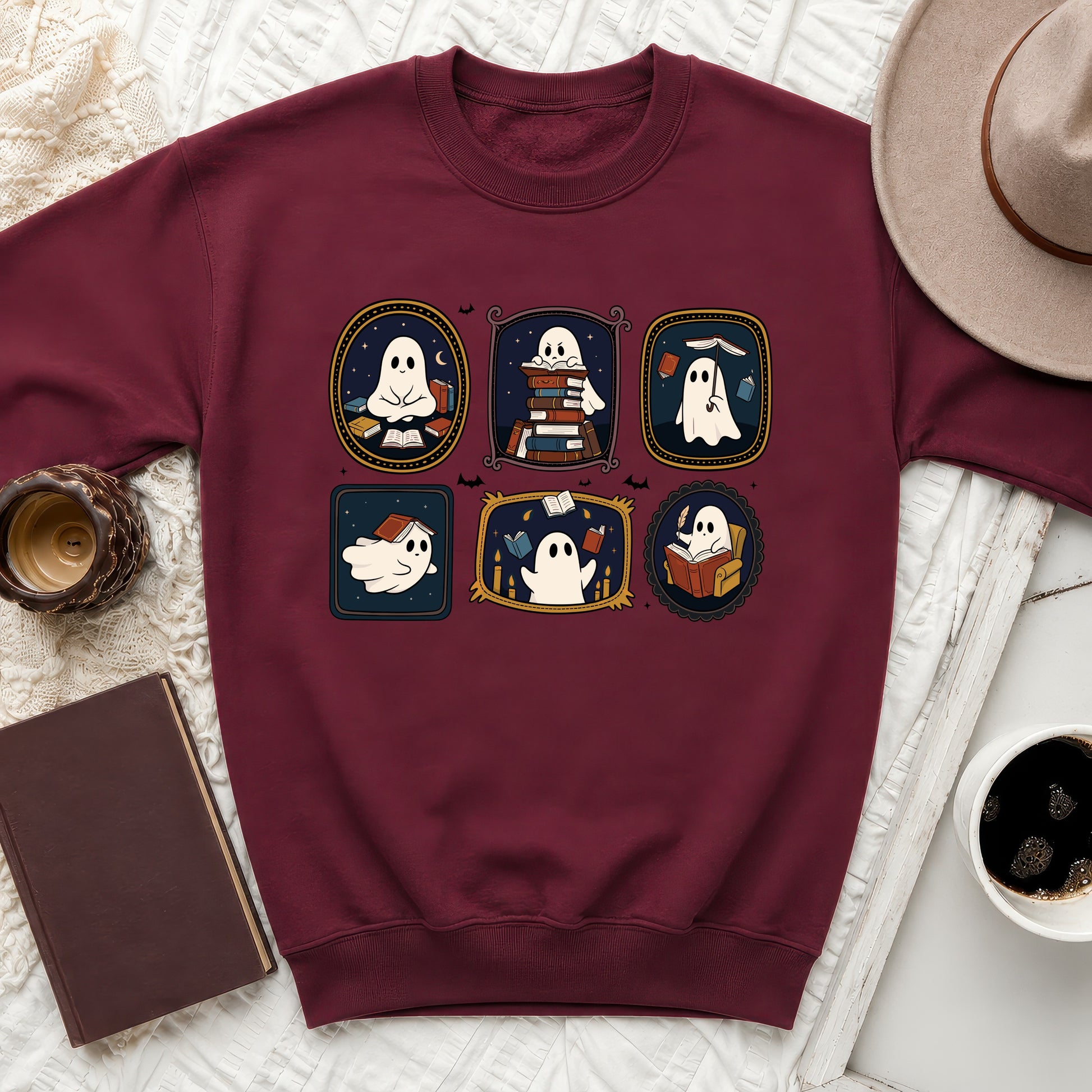 Maroon sweatshirt featuring six framed cartoon ghosts reading and interacting with books.