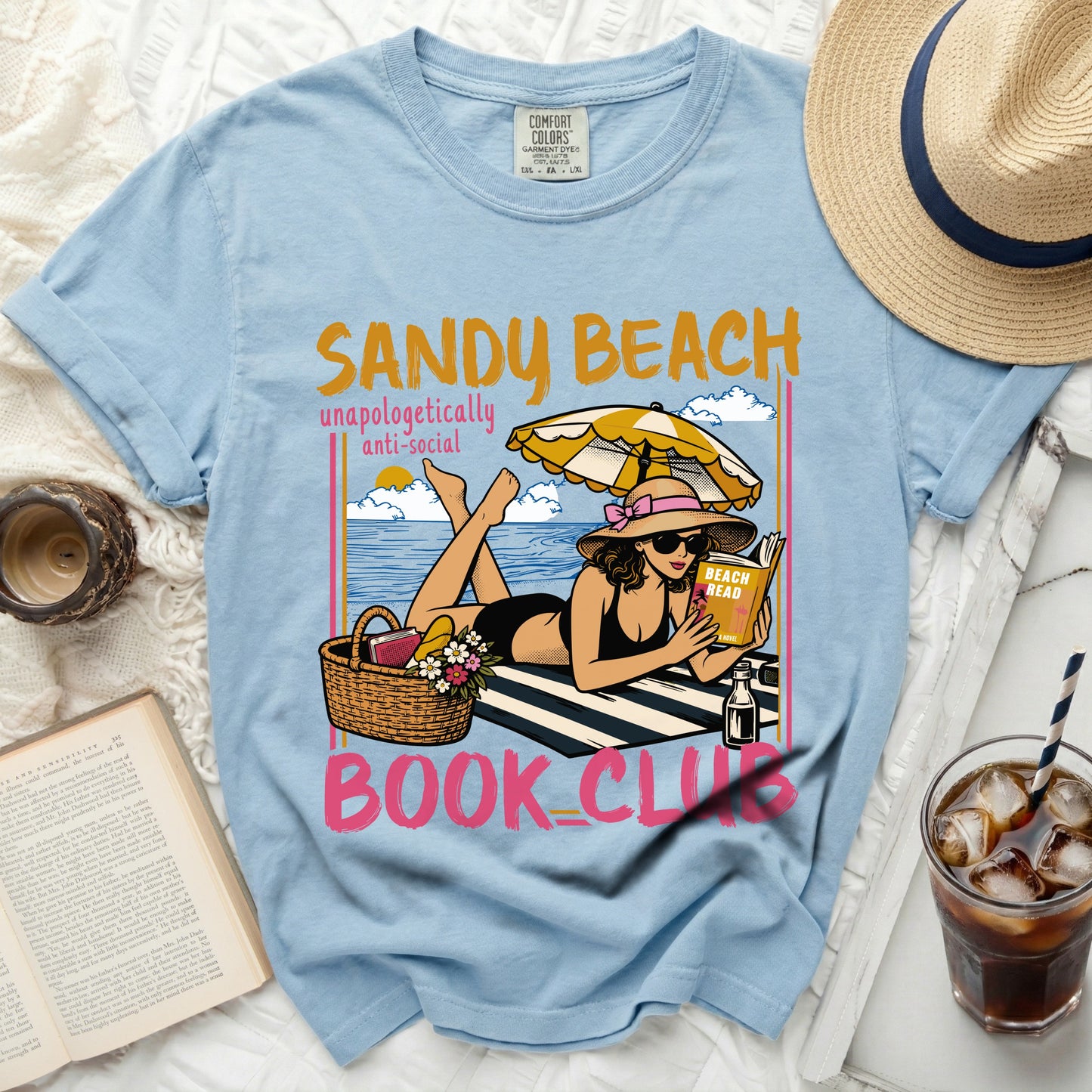 Light blue t-shirt with "Sandy Beach Book Club" graphic.