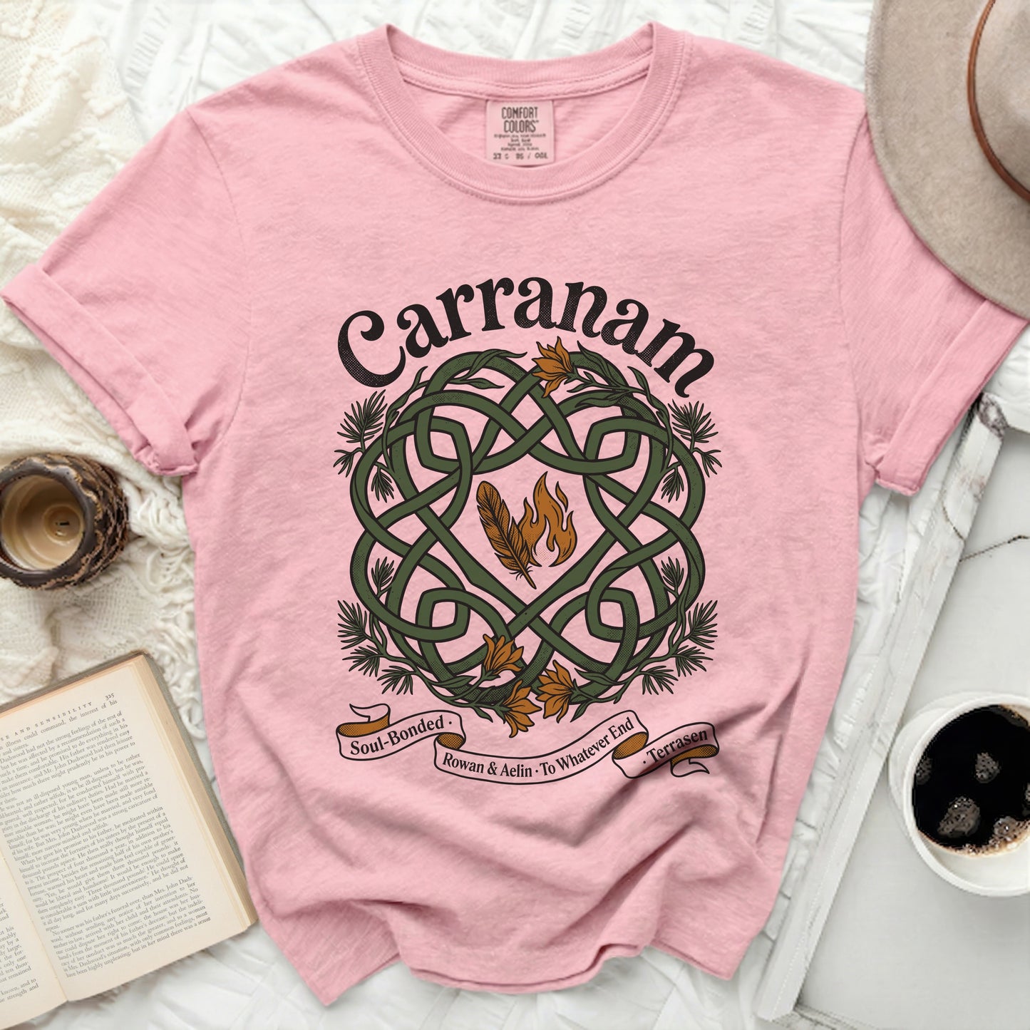 Pink t-shirt with Celtic knot, feathers, and "Carranam" text.