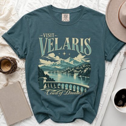 Teal t-shirt with "Visit Velaris Court of Dreams" graphic and mountainous city scene.