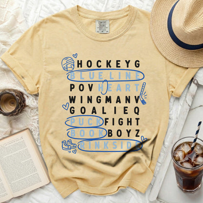 Yellow t-shirt with hockey terms listed vertically in blue letters.