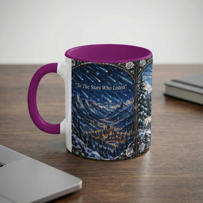 A white ceramic mug with a purple handle and rim featuring a fantasy mountain landscape illustration.
