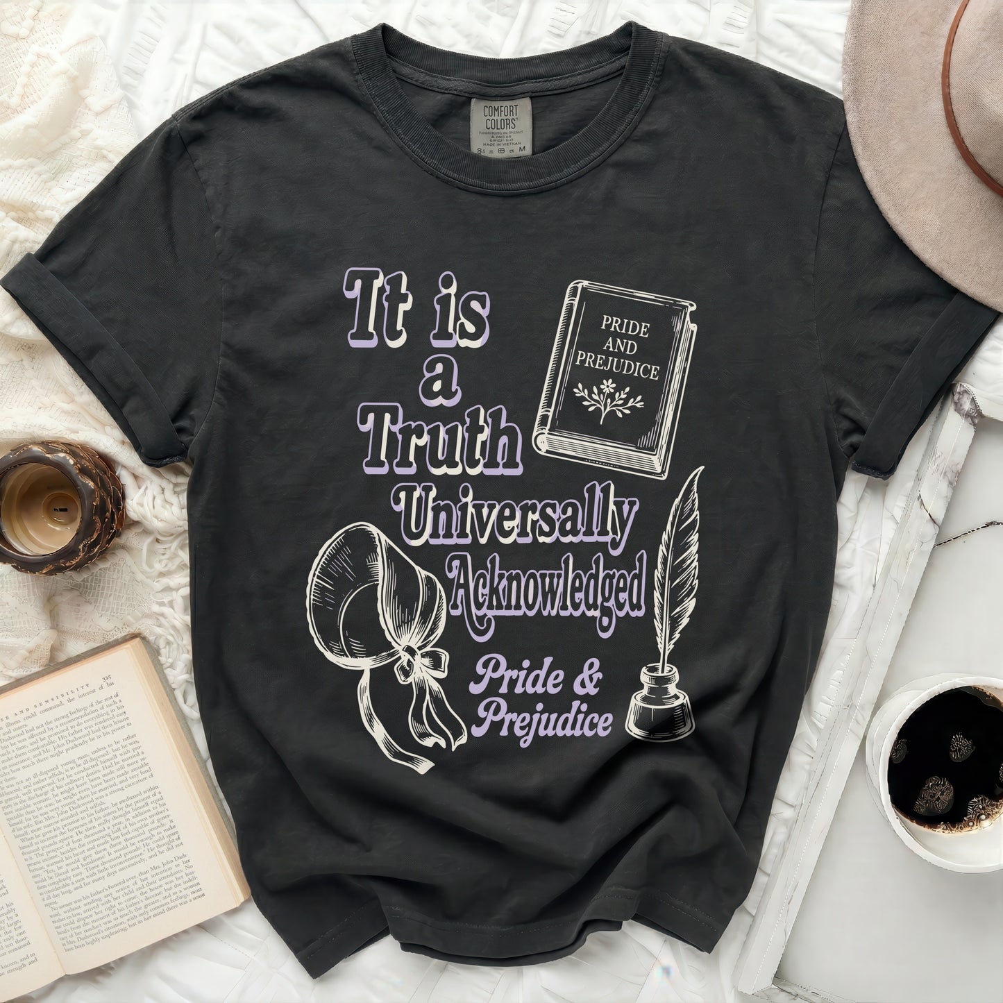 Black t-shirt with "It is a Truth Universally Acknowledged" and "Pride & Prejudice" text.