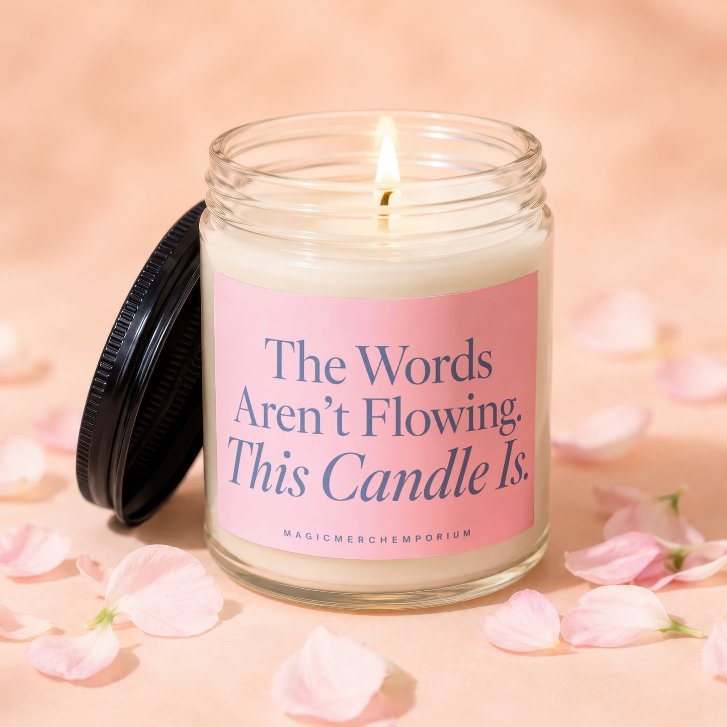 Jar candle with pink label reads "The Words Aren't Flowing. This Candle Is."
